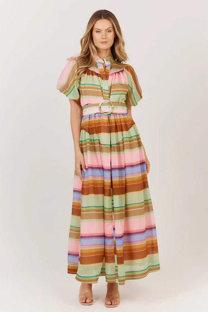 Woman wearing a colorful striped dress on a white background