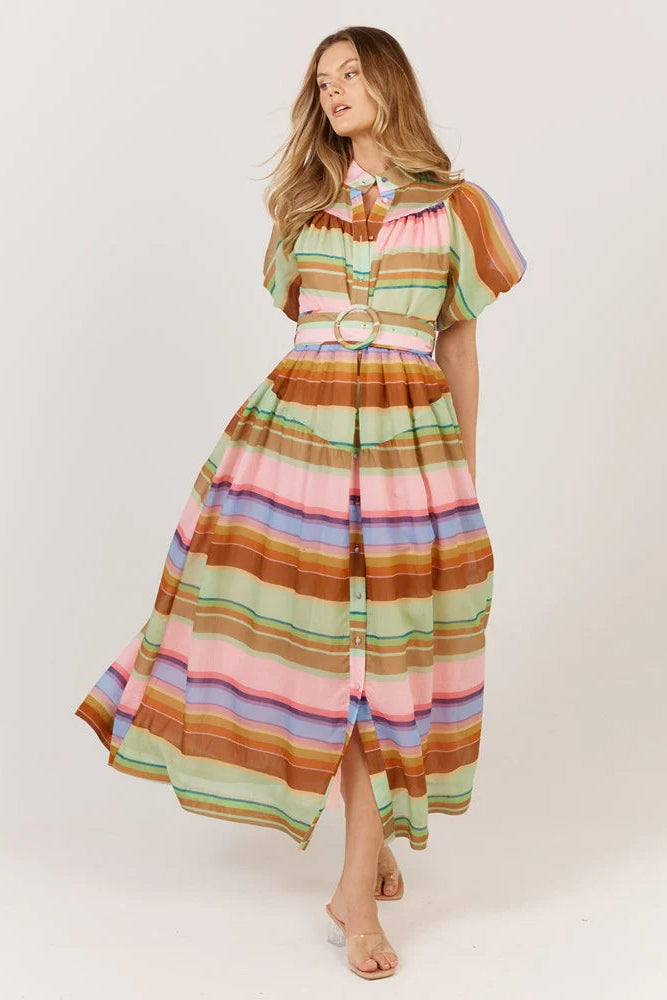 Woman wearing a colorful striped dress on a white background