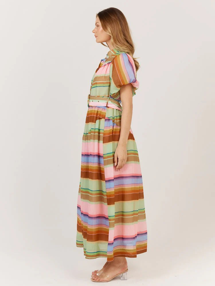Woman wearing a colorful striped dress on a white background