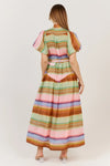 Woman wearing a colorful striped dress on a white background