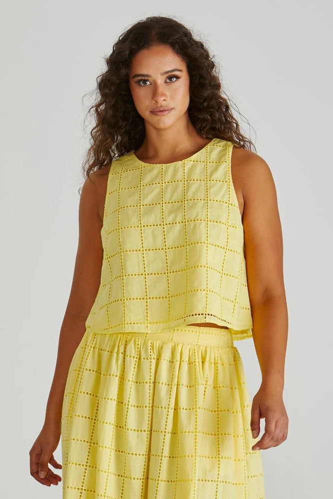 Woman wearing a yellow dress with a white background