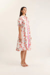 Woman wearing a floral dress on a white background