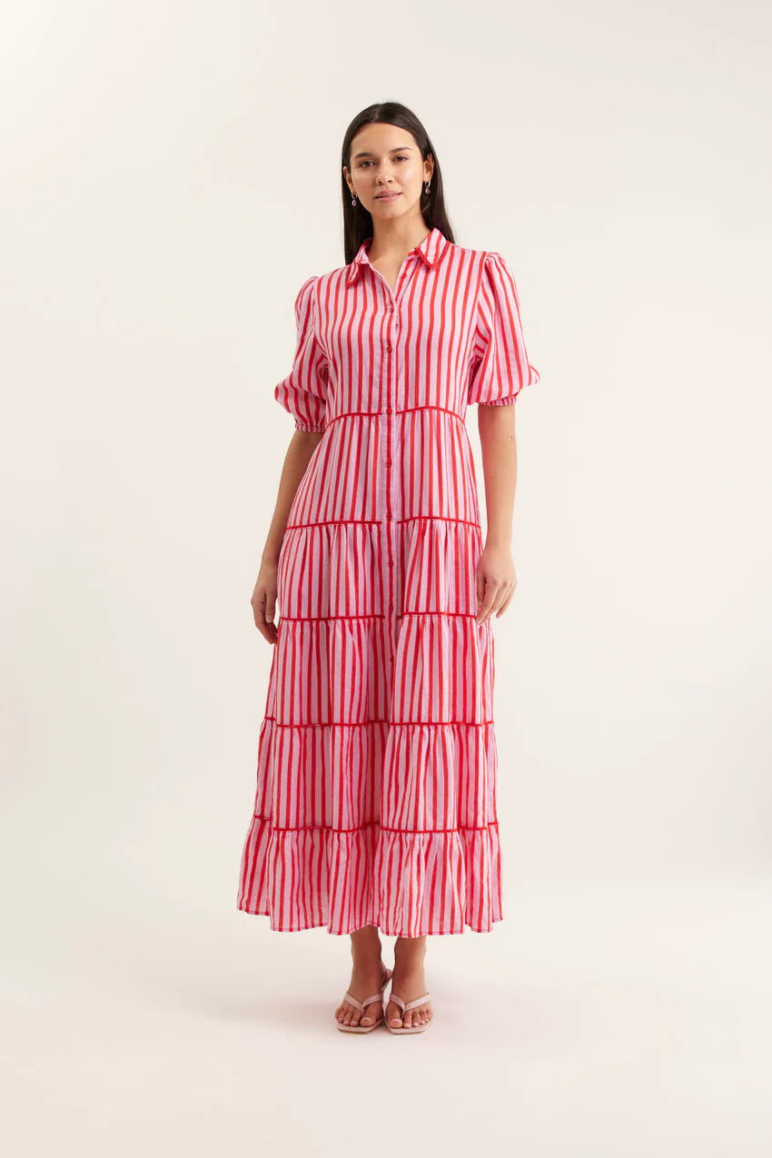 Woman wearing a red and white striped dress on a white background