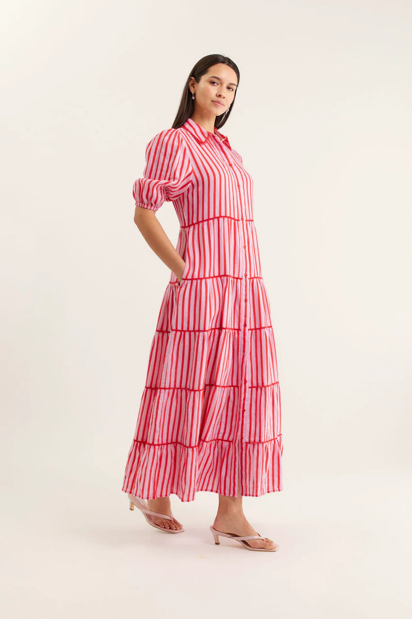 Woman wearing a red and white striped dress on a white background