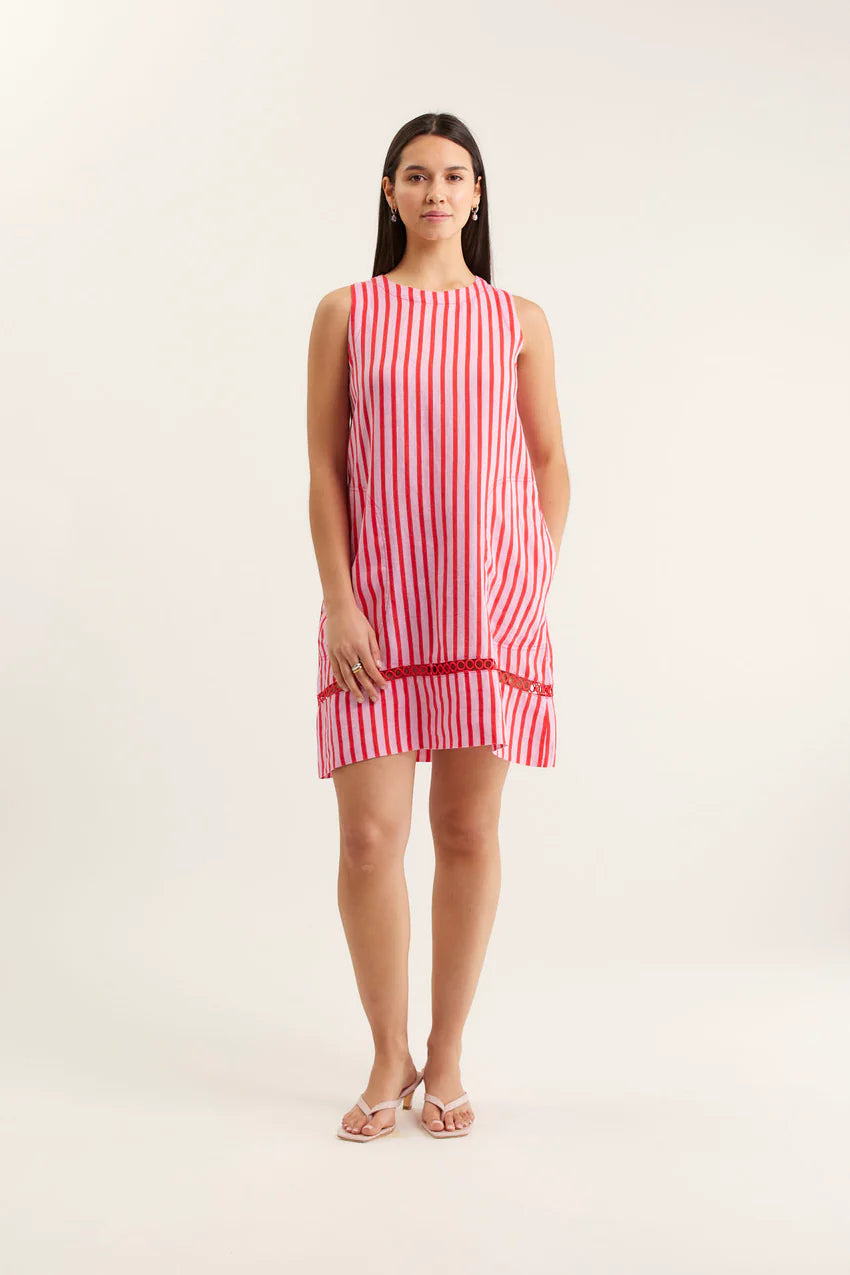 Woman wearing a red and white striped dress on a white background
