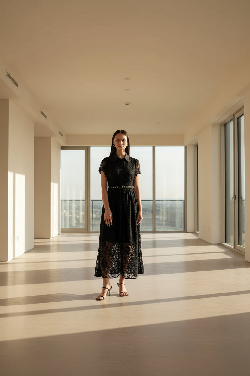 Woman wearing a black lace dress on a white background