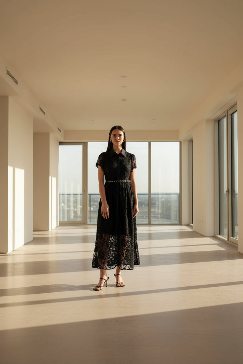 Woman wearing a black lace dress on a white background