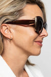 Woman wearing sunglasses with a plain background