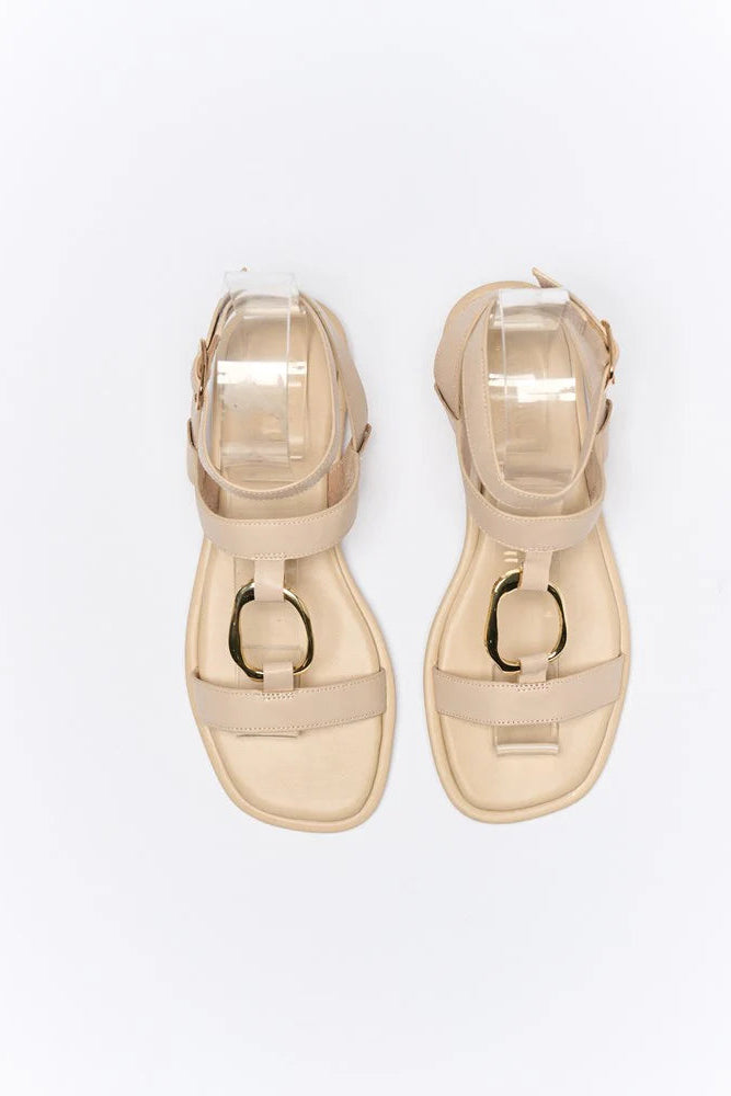 Pair of gold sandals on a white background