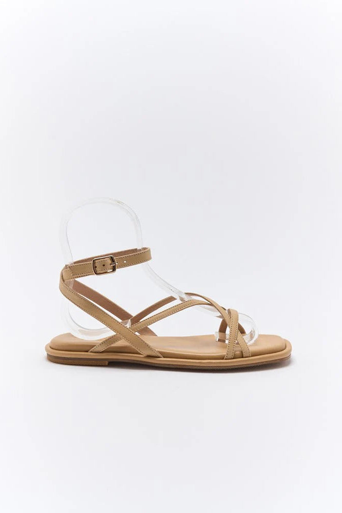 Beige sandal with clear jelly sole on a white background