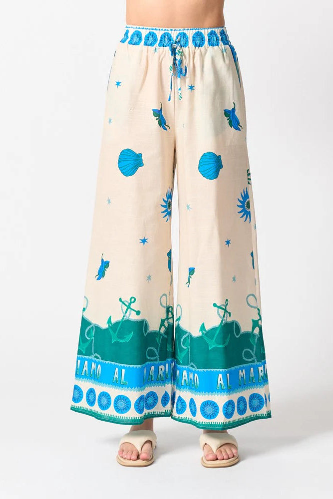 Beige pants with blue and green patterns on a white background