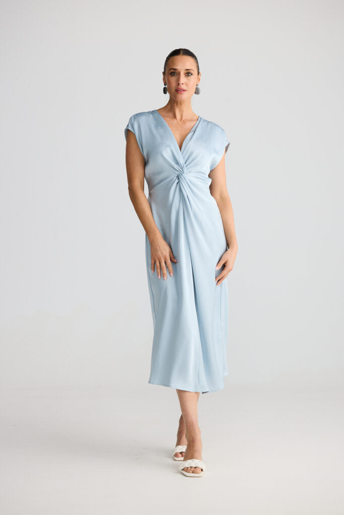 Woman wearing a light blue dress against a white background